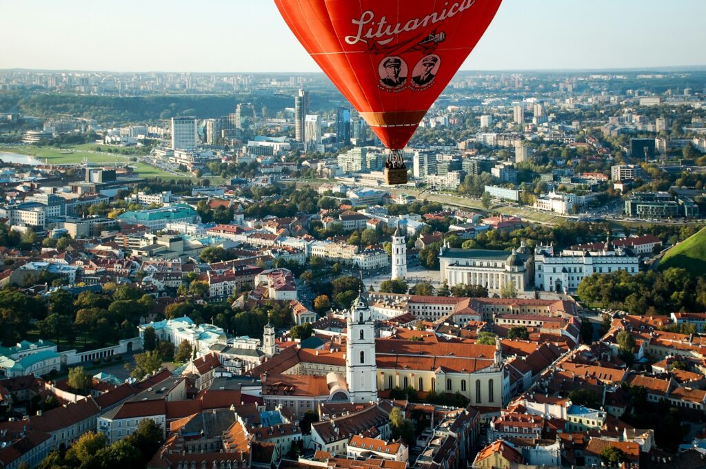 A wide view of Vilnius, Lithuania, with a hot air balloon in the foreground