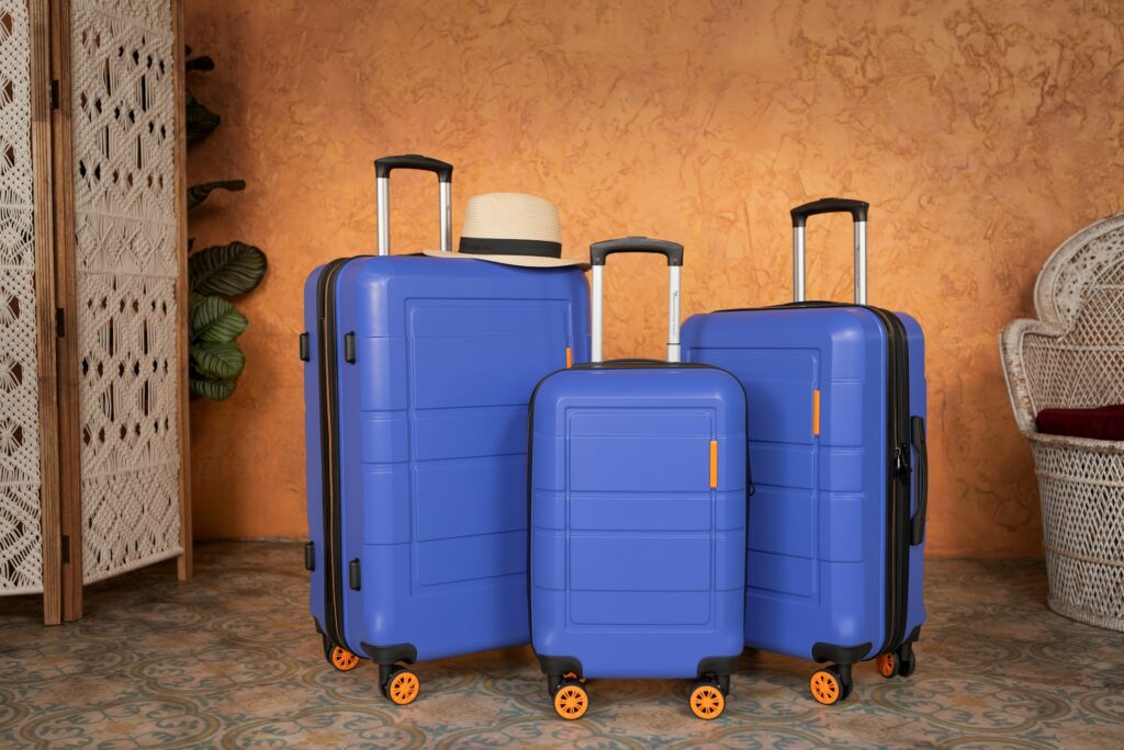 Three blue suitcases in a row